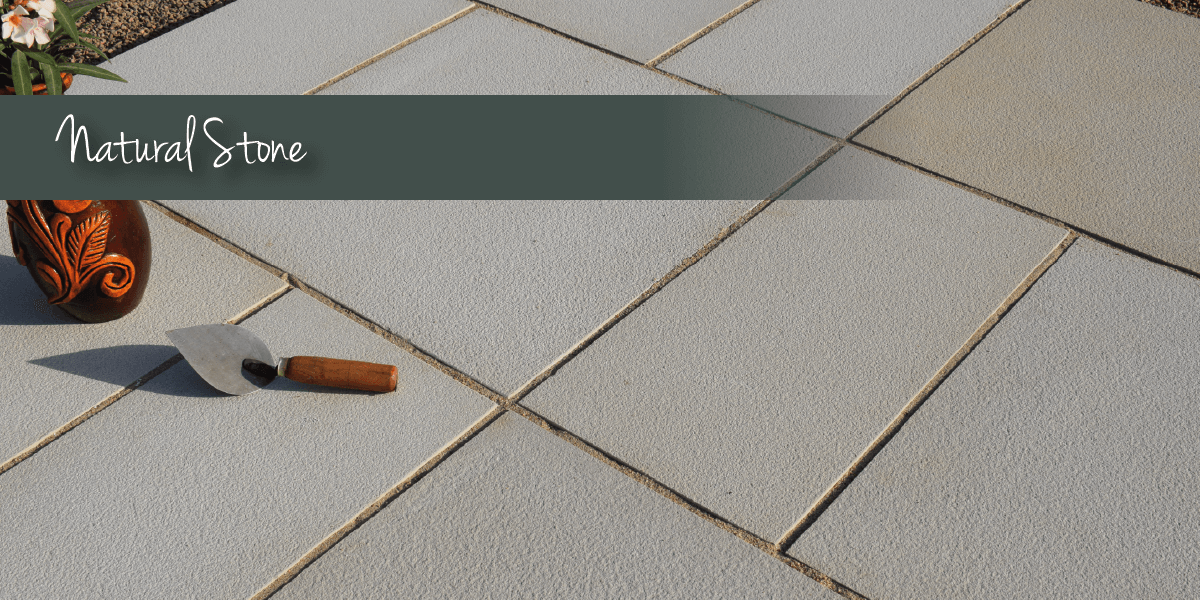 Grey titled paving with natural stone banner