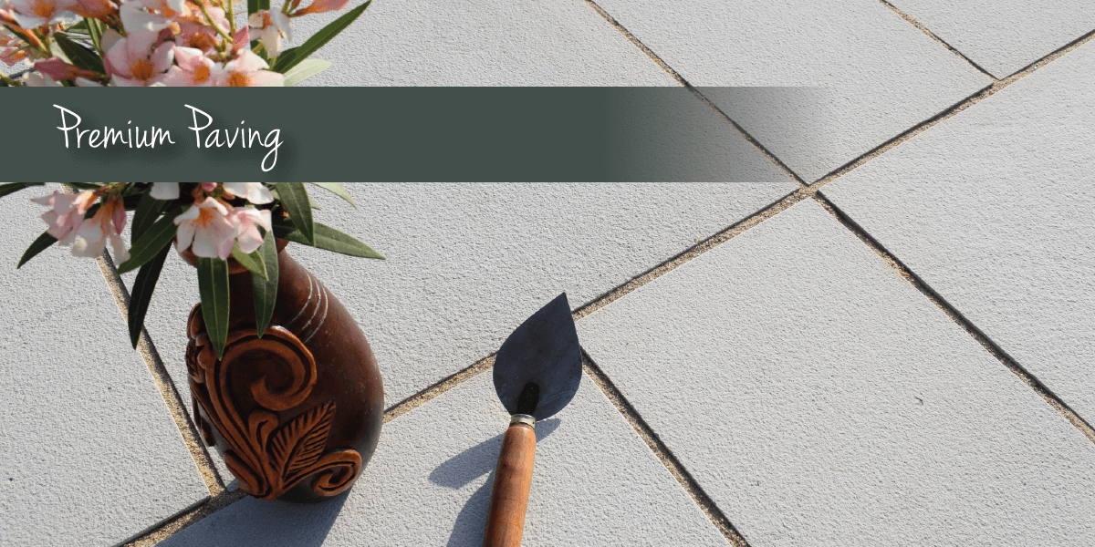 Premium paving banner with grey paving, trowel and flowers