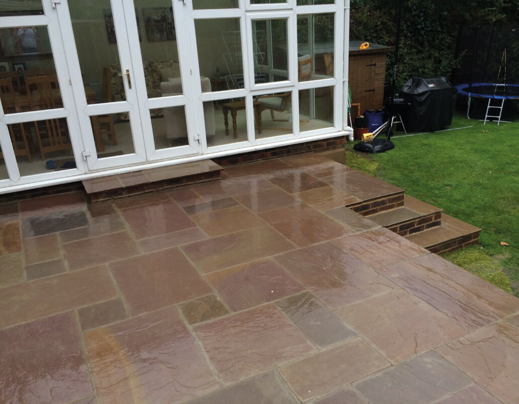 Brown garden paving outside conservatory
